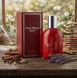 Red 'Royal Mirage Sport' cologne bottle and packaging on a wooden surface with flowers in the background