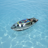 Metallic toy boat with colorful design floating on clear blue water