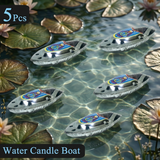 Five water candle boats on a water surface with lily pads